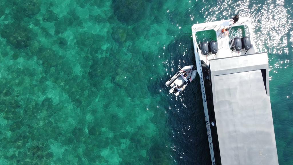 Aerial view of triple diesel outboards on a commercial vessel at dock