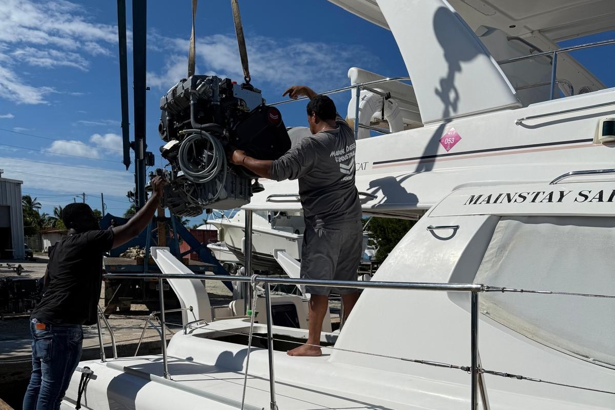 MDI crew installing a Yanmar engine into a catamaran